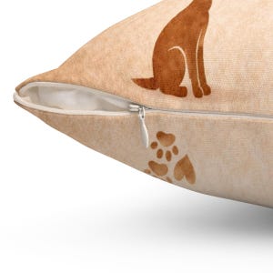 May include: A beige throw pillow cover featuring a brown silhouette of a sitting dog and a brown paw print design. The pillow cover has a visible white zipper closure along the side seam, constructed from a textured fabric material.