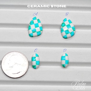May include: Ceramic stone pendants in various shapes, featuring a checkerboard pattern of white and turquoise. The image includes four pendants labeled A, B, C, and D, with a U.S. quarter for size comparison. The text "CERAMIC STONE" is at the top.
