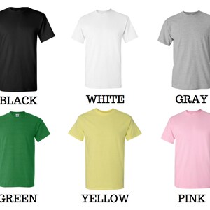 May include: Six plain t-shirts in different colors: black, white, gray, green, yellow, and pink. The shirts are all the same style, with short sleeves and a crew neck.