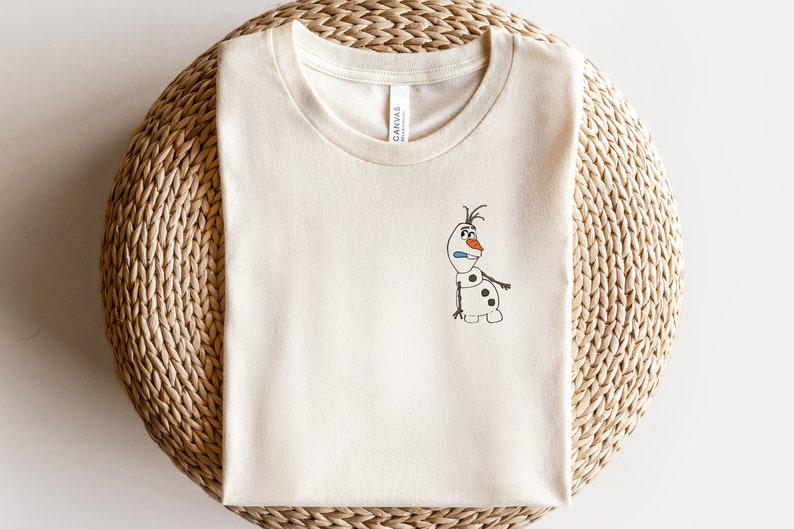 May include: A white t-shirt with a cartoon drawing of Olaf, the snowman from the movie Frozen, on the front.