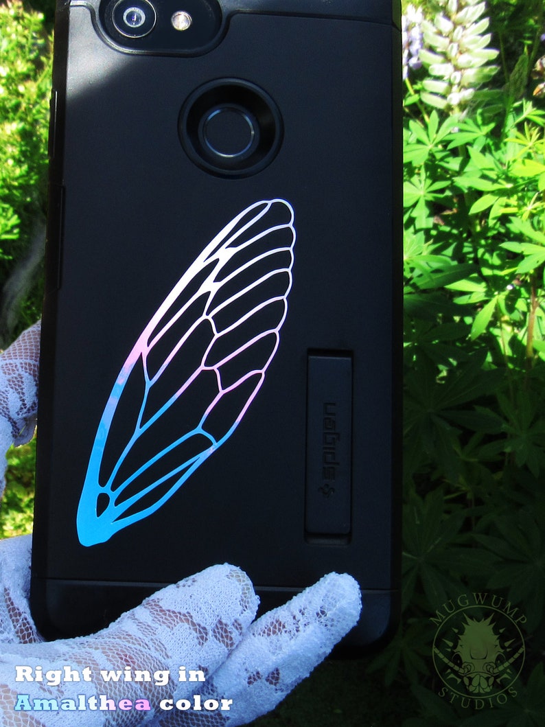 May include: A black phone case with a blue and pink insect wing design. The text "#WeRide" is on the side of the case.