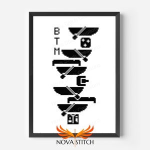 Op de afbeelding: Zwart-wit pixel art kruissteekpatroon van de letters "BTM" met een ontwerp van een videogamecontroller en een joystick. Het patroon is ingelijst in een zwart frame.