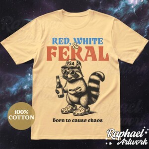 Peut inclure: Un t-shirt beige avec un raton laveur portant un chapeau USA rouge, blanc et bleu et des lunettes de soleil. Le raton laveur tient un hot-dog et une bouteille de bi&egrave;re. Le texte sur le t-shirt dit "Red, White & Feral" et "Born to cause chaos".