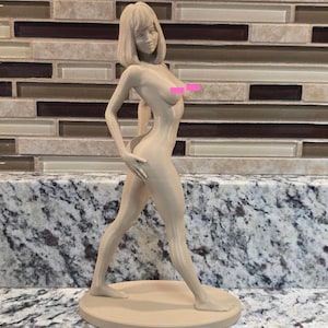 May include: A beige-colored figurine of a woman in a walking pose. The figure has short hair and is standing on a round base. The statue is made of a smooth material and is displayed against a neutral background.