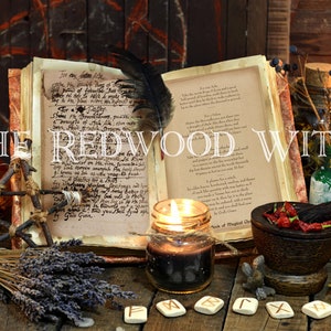 May include: An open book with handwritten text, a lit candle, a mortar and pestle with red peppers, and other witchy items on a wooden table. The text on the book reads "The Redwood Witch".