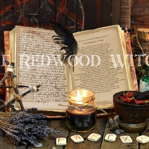 May include: An open book with handwritten text, a feather, and lit candles are featured in this image. Other items include a mortar and pestle, bottles, and the text "THE REDWOOD WITCH". The scene evokes a mystical or witchy theme.
