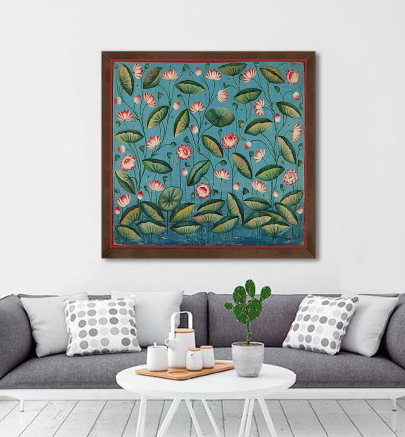 May include: A framed painting of a blue background with pink and white lotus flowers and green leaves. The painting is in a brown frame.