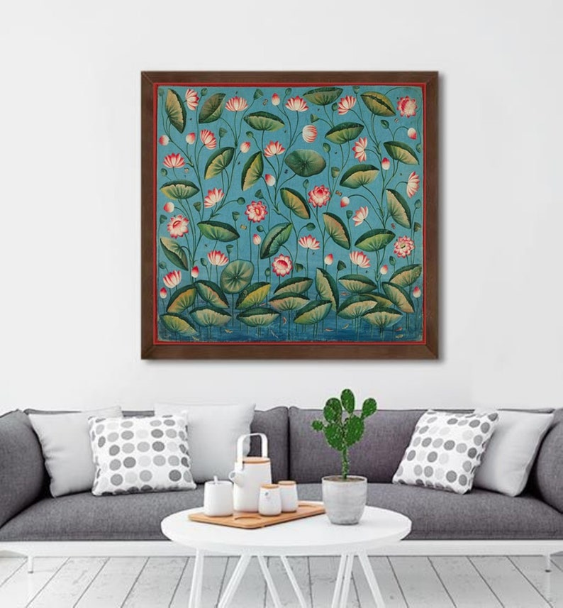 May include: A framed painting of a blue background with pink and white lotus flowers and green leaves. The painting is in a brown frame.