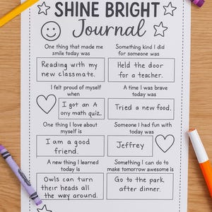 May include: A white journal page with the text "SHINE BRIGHT Journal" and prompts for daily reflections. Colored crayons and a yellow pencil are scattered around the page.