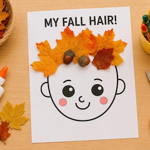 May include: A white paper sheet with the black text MY FALL HAIR! featuring a line drawing of a face. The head is decorated with orange and yellow autumn leaves and two brown acorns. The craft project is surrounded by glue, scissors, and crayons.