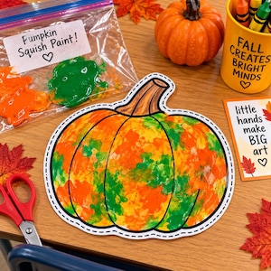 May include: A paper pumpkin cutout painted with orange and green colours, a plastic bag labelled Pumpkin Squish Paint! containing orange and green paint, a small orange pumpkin, a yellow cup with the text FALL CREATES BRIGHT MINDS, and a card with the text little hands make BIG art.