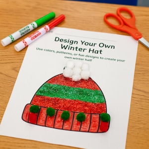 Peut inclure: Une feuille avec un dessin d'un bonnet d'hiver, avec le texte "Design Your Own Winter Hat". Le bonnet est rouge et vert avec des pompons. Des marqueurs verts et rouges et des ciseaux oranges sont sur la table.