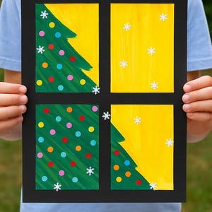 May include: A black framed artwork with four sections. Two sections show green Christmas trees with colourful baubles. The other two sections have a yellow background with white snowflakes. The artwork is held by a person.