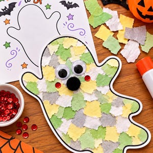 May include: A ghost-shaped craft project covered in small, torn pieces of green, yellow, and white paper. It features two large googly eyes, a small black pom-pom nose, and two red sequin cheeks. A colouring sheet with the text Too Cute to Spook is nearby.