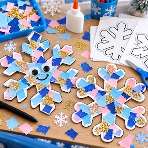 May include: Two snowflake-shaped paper cutouts decorated with small squares of blue, light blue, pink, and gold glitter paper. One snowflake features two large googly eyes and a black drawn smile. Craft supplies include glue, scissors, and paper templates.