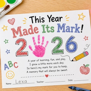 May include: A colorful school certificate with the text "This Year Made Its Mark!" and the numbers "26". It includes a pink handprint, stars, hearts, and a pencil illustration. The name "Lexa" is written on the certificate.
