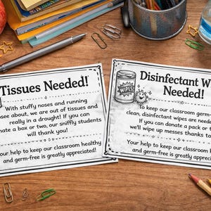 May include: Two printed signs on a wooden desk, one reading "Tissues Needed!" and the other "Disinfectant Wipes Needed!". The signs are surrounded by school supplies, including pencils, paperclips, and a red apple.