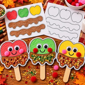 May include: Three apple-shaped paper crafts on lolly sticks, coloured red, green, and yellow with googly eyes, pink pom-pom cheeks, and glittery brown bases. Two printed activity sheets with apple and drip outlines are visible in the background.