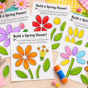 May include: A selection of spring flower craft kits with the text "Build a Spring Flower!". The kits feature pre-cut flower pieces, green leaves, and instructions. Scissors, glue, and decorative flowers are also present.