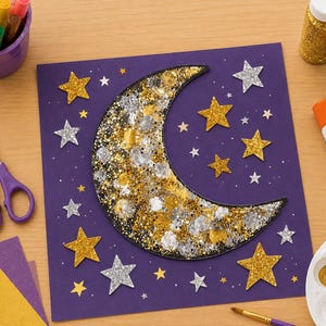 May include: A square purple craft paper featuring a large crescent moon cutout covered in gold and silver glitter. The moon is surrounded by several smaller gold and silver glitter star cutouts. Craft supplies including scissors, glue, and paint are nearby.