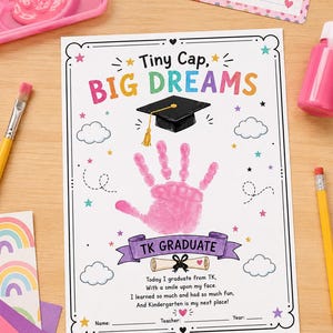 May include: A graduation keepsake featuring the text "Tiny Cap, Big Dreams" and a handprint. The design includes a graduation cap, stars, and the words "TK Graduate." A name tag with the name "Sophia" is also visible.