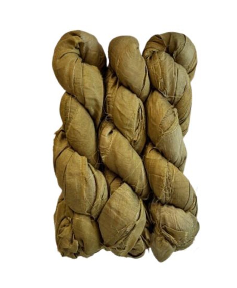 May include: Three skeins of olive green silk ribbon arranged side by side. The ribbon has a crinkled, textured appearance with visible frayed edges along the length of the fabric, creating a rustic and organic look for various craft projects.
