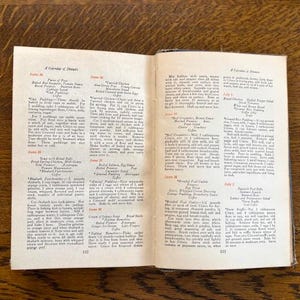 May include: A vintage cookbook open to pages for June 28th and June 29th. The pages list recipes for "Soup with Bread Balls", "Baked Salmon", "Creamed Chicken", "Baked Rice Pudding", "Broiled Fowl", "Spanish Puff Balls", "Lettuce and Pepper Salad", and "Baked Rice Pudding".