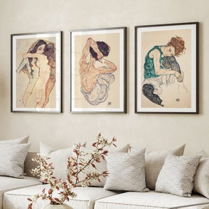 Set of three Egon Schiele prints featuring Two Women Embracing (1911), Seated Woman Back (1917), and Seated Woman with Legs Drawn Up (1917), expressive figure drawings in Schiele’s signature style.