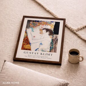 May include: A framed art print featuring a detail from Gustav Klimt's painting The Three Ages of the Woman, depicting a mother and child. The print includes the text GUSTAV KLIMT and Mother and Child detail from The Three Ages of the Woman (1905).
