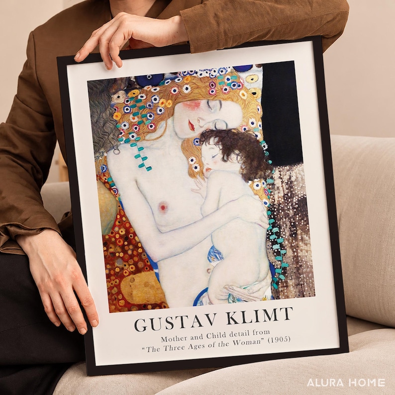 May include: A framed art print featuring Gustav Klimt's Mother and Child detail from The Three Ages of the Woman, 1905. The artwork depicts a pale woman with reddish hair holding a child, set against a dark background with gold accents.