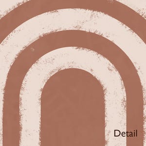 May include: A graphic print featuring concentric arch shapes in shades of terracotta and cream. The design displays a textured, distressed paint effect along the edges of the arches. The word Detail is printed in the bottom right corner in brown.