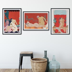 May include: Three framed illustrations of nude figures in various poses against a red background. The illustrations are in a minimalist style with black outlines and muted colours. The frames are black and the illustrations are hung on a white wall.