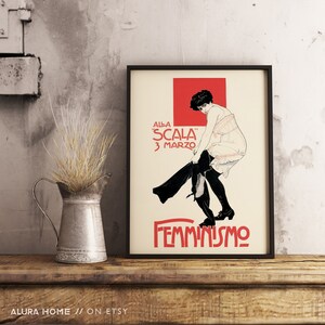 May include: A vintage poster with a black frame, featuring a woman in a white dress and black pants, with the text "ALLA "SCALA" 3 MARZO" and "FEMMINISMO" in red and black.