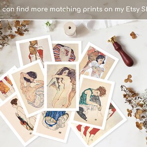 May include: A collection of art prints featuring nude figures in various poses. The prints have a vintage aesthetic with muted colors and fine lines. The text "You can find more matching prints on my Etsy Shop" is visible. A wooden handled wax stamp and dried flowers are also present.