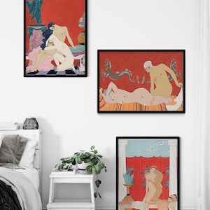 May include: Three framed art prints featuring nude figures in various poses. The prints are set against a white wall with a white bed and a white stool with a green plant in the foreground. The prints are all in black frames and feature a red background with black and white details.