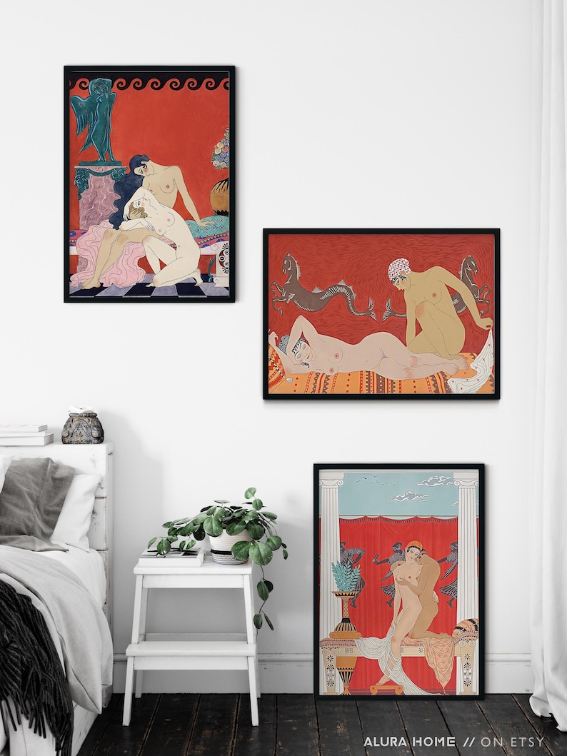 May include: Three framed art prints featuring nude figures in various poses. The prints are set against a white wall with a white bed and a white stool with a green plant in the foreground. The prints are all in black frames and feature a red background with black and white details.