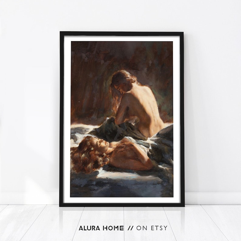 A romantic figurative print showing two women resting together on soft fabric, painted in warm shadowed tones with a sensual, intimate atmosphere.