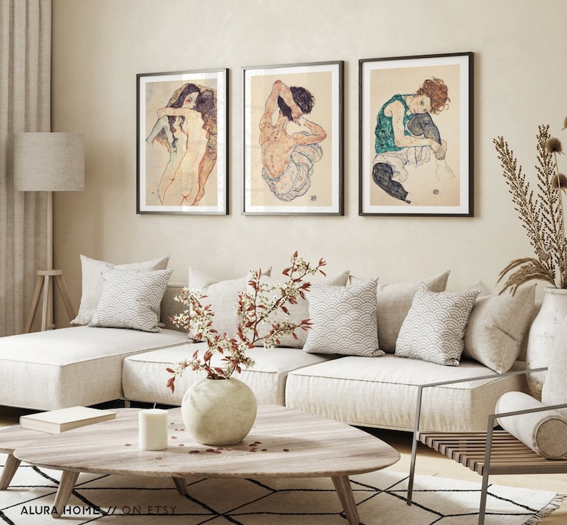 Set of three Egon Schiele prints featuring Two Women Embracing (1911), Seated Woman Back (1917), and Seated Woman with Legs Drawn Up (1917), expressive figure drawings in Schiele’s signature style.