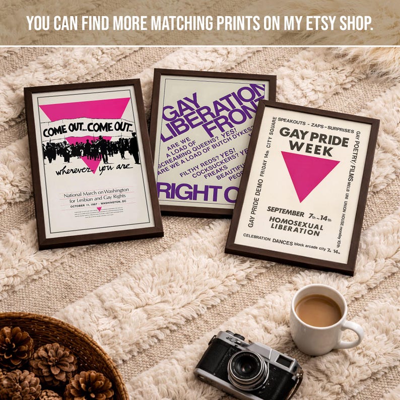 May include: Three framed posters featuring historical LGBTQ+ activism graphics. The left poster displays a pink triangle and text reading Come Out... Come Out... wherever you are. The center poster features purple text reading GAY LIBERATION FRONT. The right poster shows a pink triangle and text reading GAY PRIDE WEEK.