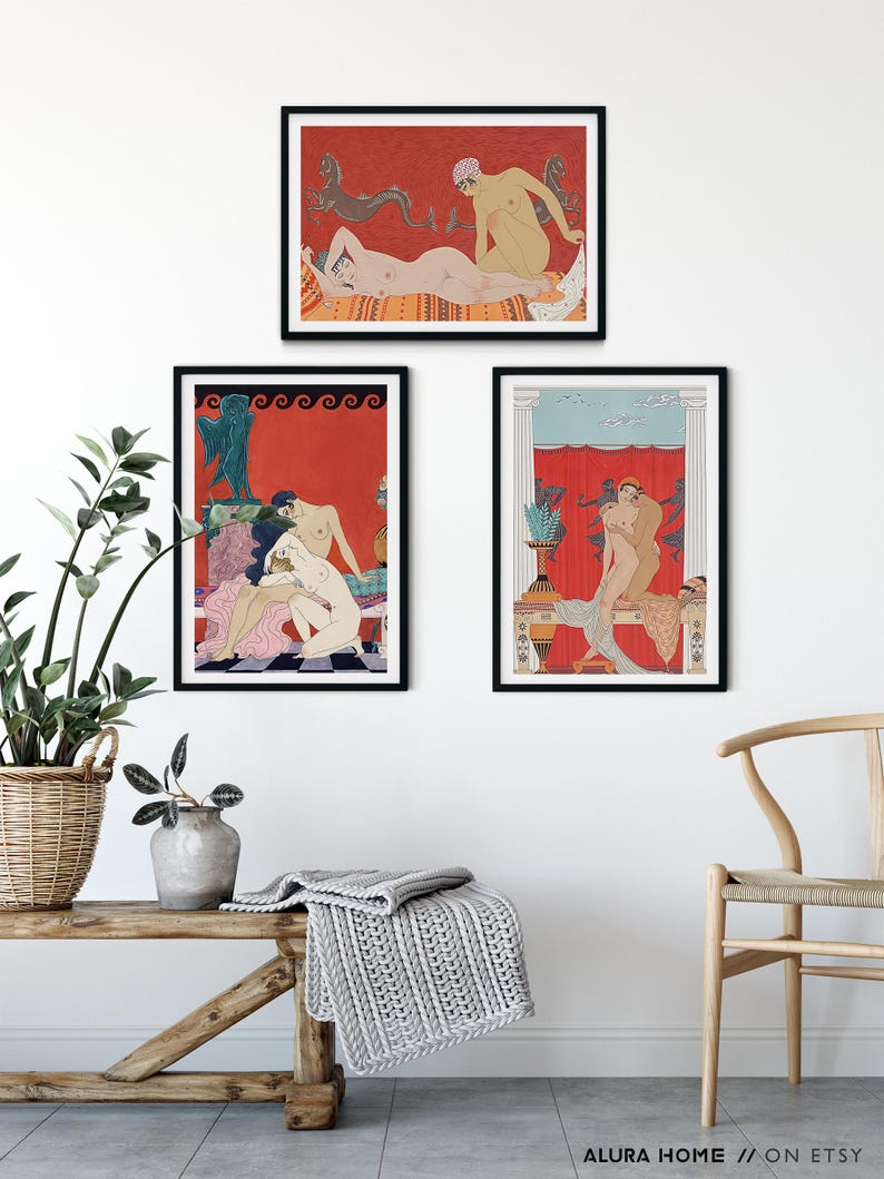 May include: Three framed art prints with a red background and black frames. The prints feature stylised illustrations of figures in various poses. The prints are hung on a white wall with a wooden bench and a chair in the foreground.