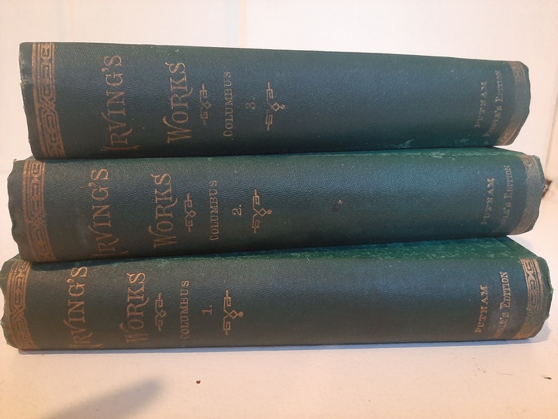 May include: Three green hardcover books stacked on top of each other. The books are titled "Irving's Works" and each book has a different volume number. The books are part of the Putnam's Edition.