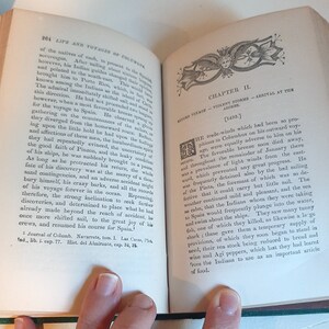 May include: A page from a book titled "Life and Voyages of Columbus" with text about the return voyage of Columbus in 1493. The text describes the challenges faced by Columbus and his crew, including unfavorable winds, a leaky ship, and the need to replenish their food supply.