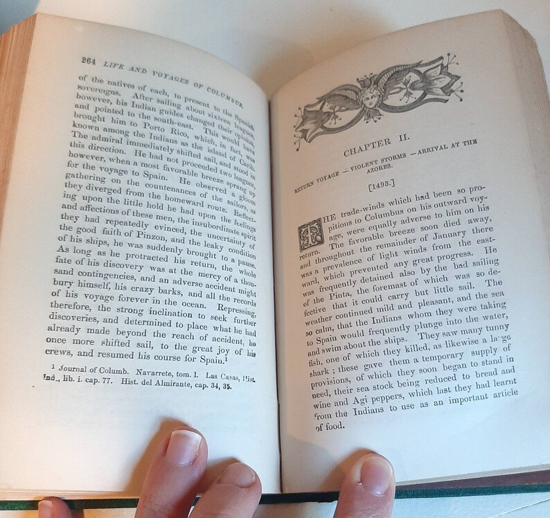 May include: A page from a book titled "Life and Voyages of Columbus" with text about the return voyage of Columbus in 1493. The text describes the challenges faced by Columbus and his crew, including unfavorable winds, a leaky ship, and the need to replenish their food supply.