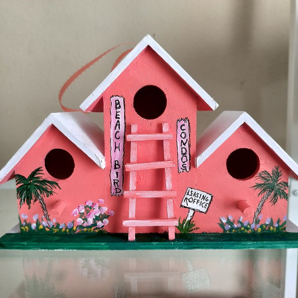 Beach lovers will fall in love with this Beach Bird Condos hand painted birdhouse.