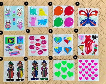 May include: A sheet of colorful stickers featuring various themes, including butterflies, hearts, clowns, computers, and cats. The stickers are arranged in a grid pattern on a light brown background.