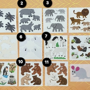 以下が含まれることがあります： クモ、カバ、ゾウ、ライオン、ホッキョクグマ、幽霊、馬、猫、クマ、ネズミなど、動物をテーマにしたステッカーのコレクション。ステッカーはさまざまな色とスタイルです。