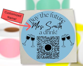 May include: Custom QR code stickers. The central sticker has a blue circle design with the text "Buy the future Mrs. Smith a drink!" and a QR code. The text "Custom QR Code Stickers!" is at the top. The text "Message me the custom name and QR code after ordering!" is at the bottom.