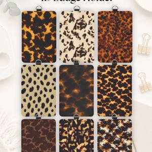 May include: A collection of nine rectangular ID badge holders featuring various tortoise shell and animal print patterns in shades of brown, black, tan, and cream. Each holder includes a small metal loop at the top for attachment purposes.