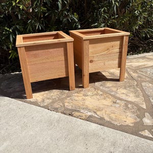 May include: A rustic wooden sign with the text "Welcome to our home" in white lettering. The sign features a distressed finish and a simple, inviting design, perfect for entryway decor.