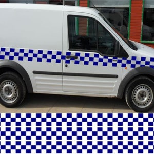 May include: A white van with a blue and white checkered stripe along the side. The stripe is made up of squares.